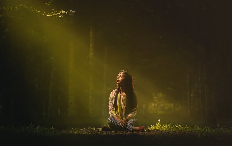 Woman practicing yoga in a forest
